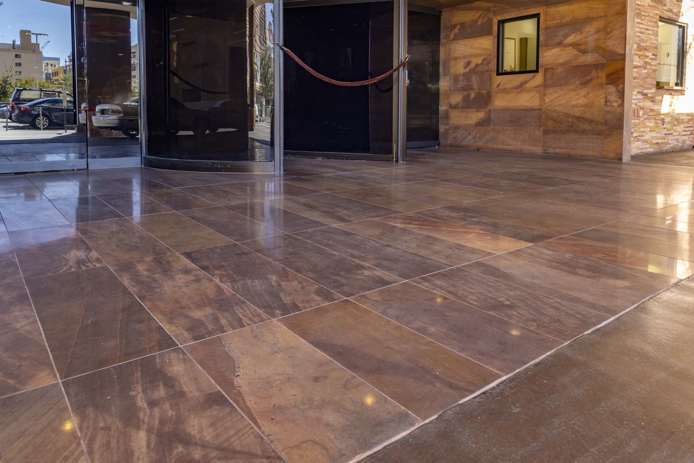 Polished stone tile entrance and revolving door at the Golden Gate Hotel porte cochere.