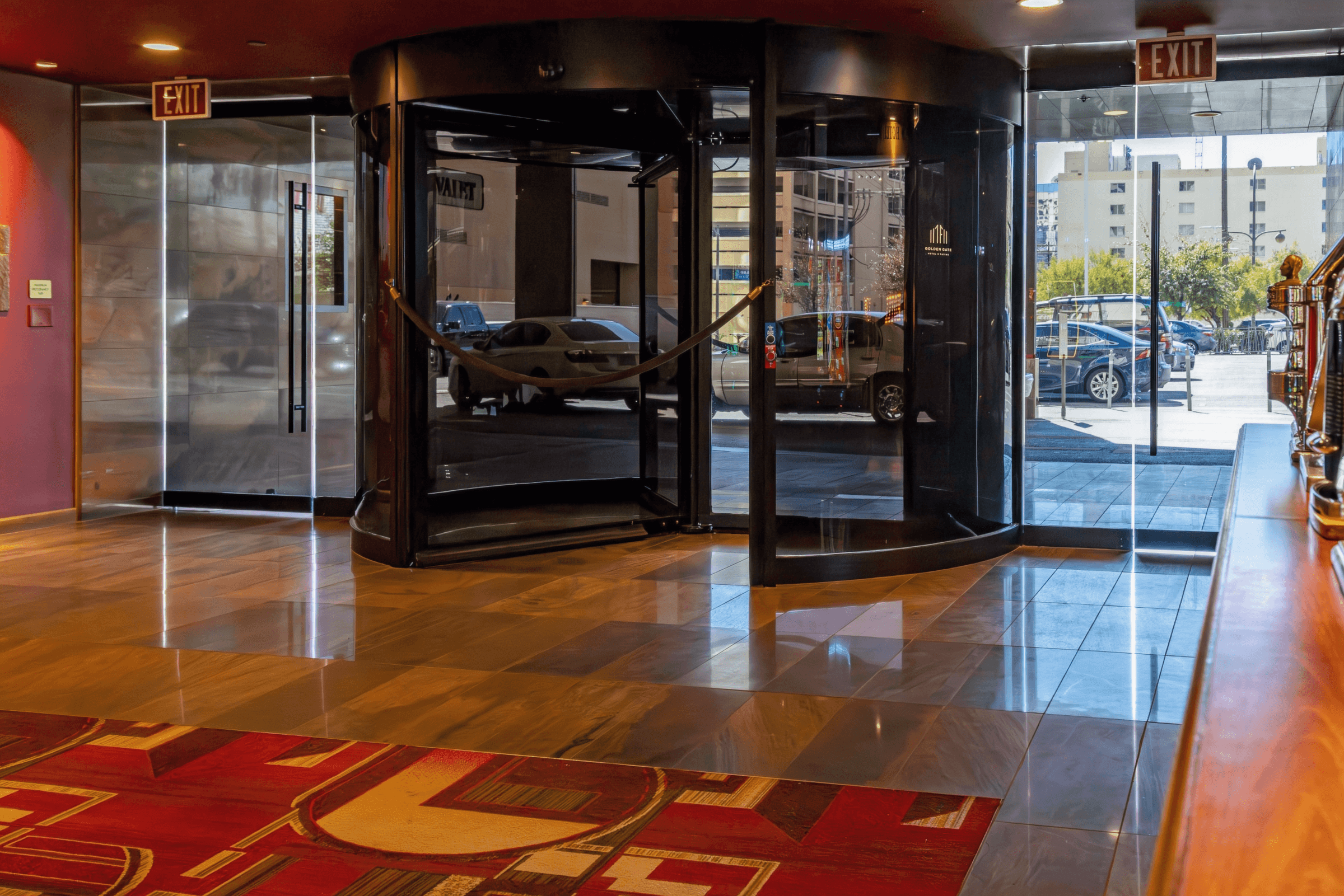 Golden Gate Hotel lobby with polished marble floor tile and revolving entrance doors.